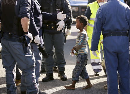 A barefooted child walks out after disembarking from tug boat Asso29 in the Sicilian harbour of Pozzallo, southern Italy, May 4, 2015. REUTERS/Antonio Parrinello