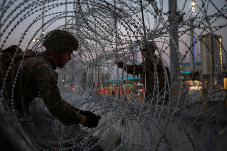United States Marines fortify concertina wire along the San Ysidro Port of Entry border crossing as seen from Tijuana, Mexico November 20, 2018. REUTERS/Adrees Latif