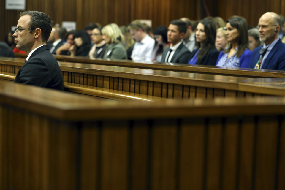 Oscar Pistorius, left, listens to cross examination during his trial in court in Pretoria, South Africa, Thursday, March 13, 2014, Pistorius is charged with the shooting death of his girlfriend Reeva Steenkamp on Valentine's Day in 2013. (AP Photo/Themba Hadebe, Pool)