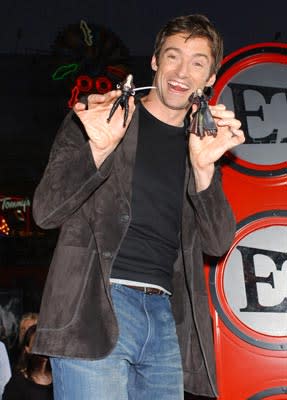 Hugh Jackman plays with the action figures from him movie at the L.A. premiere of Universal Pictures' Van Helsing