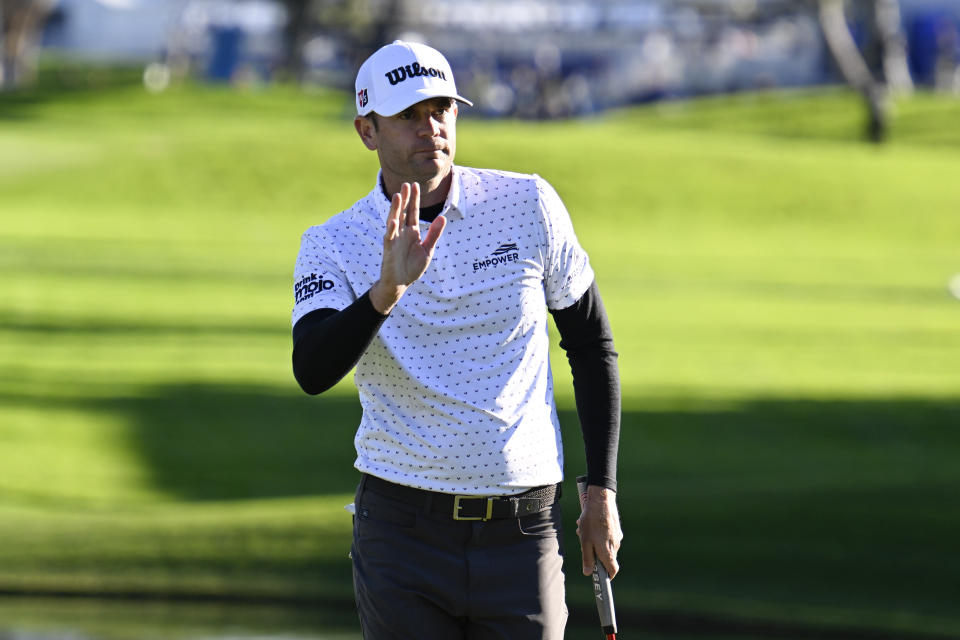 Sam Ryder acknowledges the gallery after finishing his round on the 18th hole of the South Course at Torrey Pines during the second round of the Farmers Insurance Open golf tournament, Thursday, Jan. 26, 2023, in San Diego. (AP Photo/Denis Poroy)