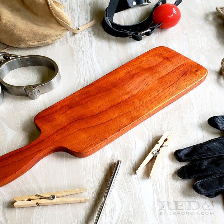 Wood paddle surrounded by objects