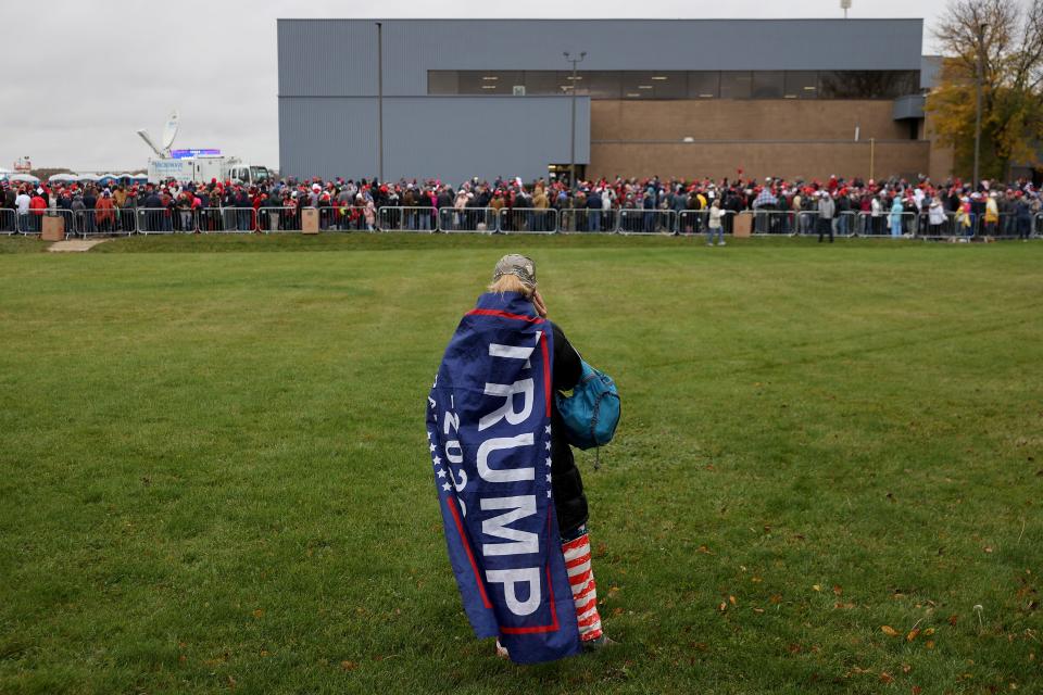 Thousands of supporters stand in line hoping to attend a campaign rally with President Donald Trump at Capital Region International Airport on Oct. 27, 2020, in Lansing, Mich.