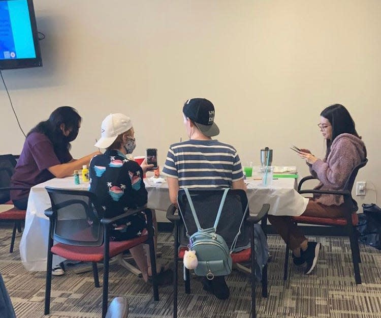 Students paint during an event at the LGBTQ resource center at the University of Houston on April 14, 2022.