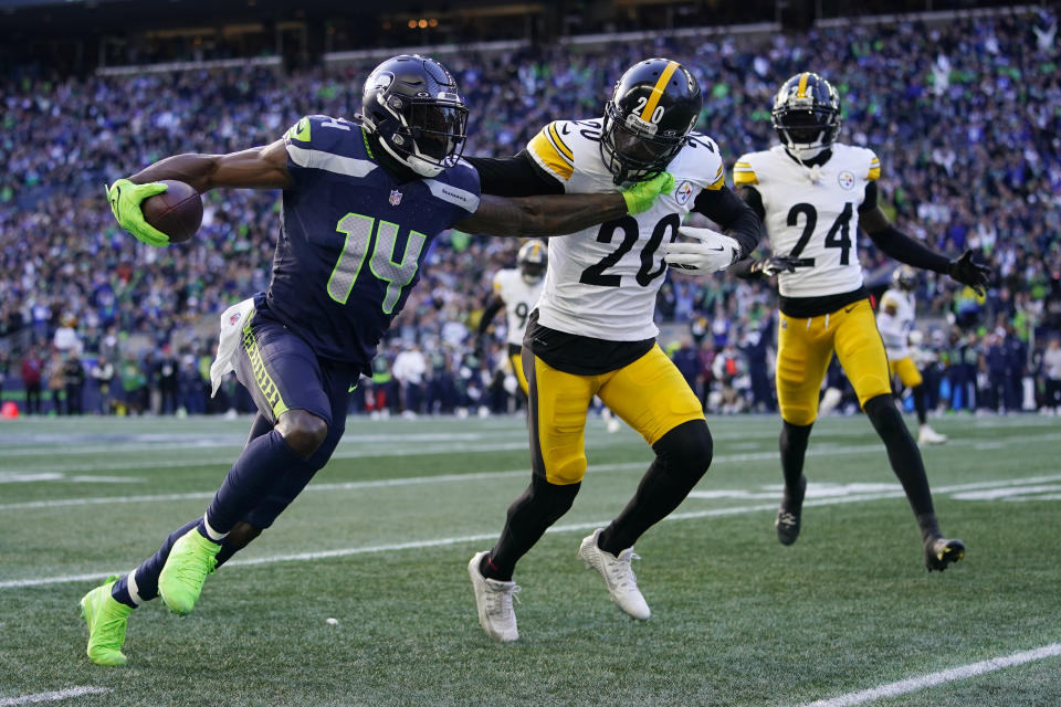 Seattle Seahawks wide receiver DK Metcalf (14) gets past Pittsburgh Steelers cornerback Patrick Peterson (20) in the first half of an NFL football game Sunday, Dec. 31, 2023, in Seattle. (AP Photo/Lindsey Wasson)