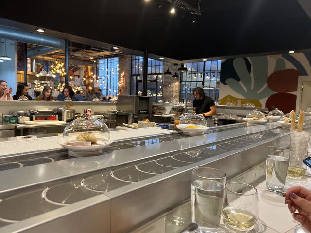 <p>Meredith Milstein</p> Culture + Co. charcuterie conveyor belt in L&L Market