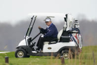 President Donald Trump drives a golf cart as he golfs at Trump National Golf Club in Sterling, Va., Sunday, Nov. 22, 2020. (AP Photo/Manuel Balce Ceneta)