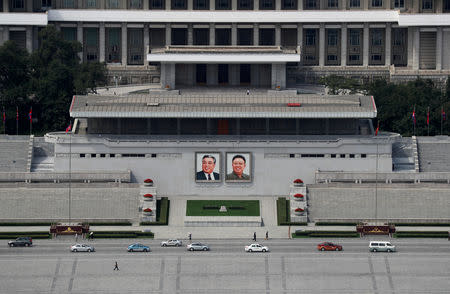 Traffic moves past the portraits of late North Korean leaders Kim Il Sung and Kim Jong Il at the main Kim Il Sung square in Pyongyang, North Korea, September 11, 2018. REUTERS/Danish Siddiqui