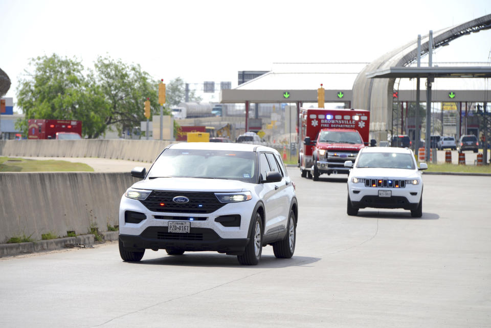 FBI units escort two Brownsville Fire Department EMS Ambulances through Veterans International Bridge at Los Tomates with two surviving U.S. citizens being transported to Valley Regional Medical Center Tuesday, March 7, 2023 in Brownsville, Texas. A road trip to Mexico for cosmetic surgery ended with two Americans dead — and two others found alive in a rural area near the Gulf coast — after a violent shootout and abduction that was captured on video, officials said Tuesday. (Miguel Roberts/The Brownsville Herald via AP)