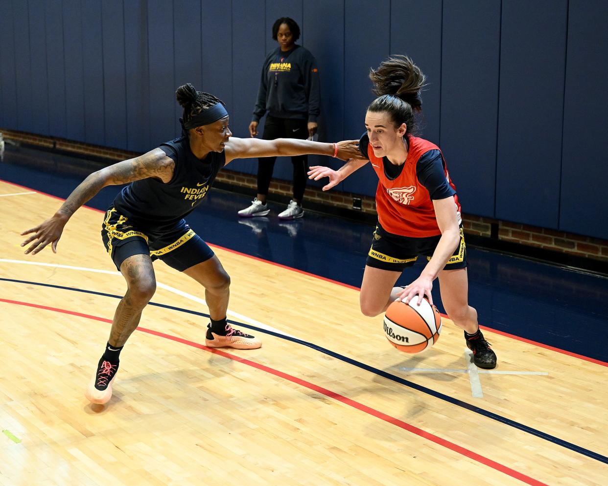 Caitlin Clark tries to dribble past Erica Wheeler on the first day of Indiana Fever training camp, April 28, 2024.