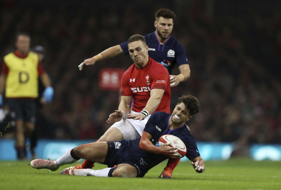 Scotland's Adam Hastings is tackled by Wales' George North during the rugby union international match at The Principality Stadium, Cardiff, Wales, Saturday Nov. 3, 2018. (David Davies/PA via AP)