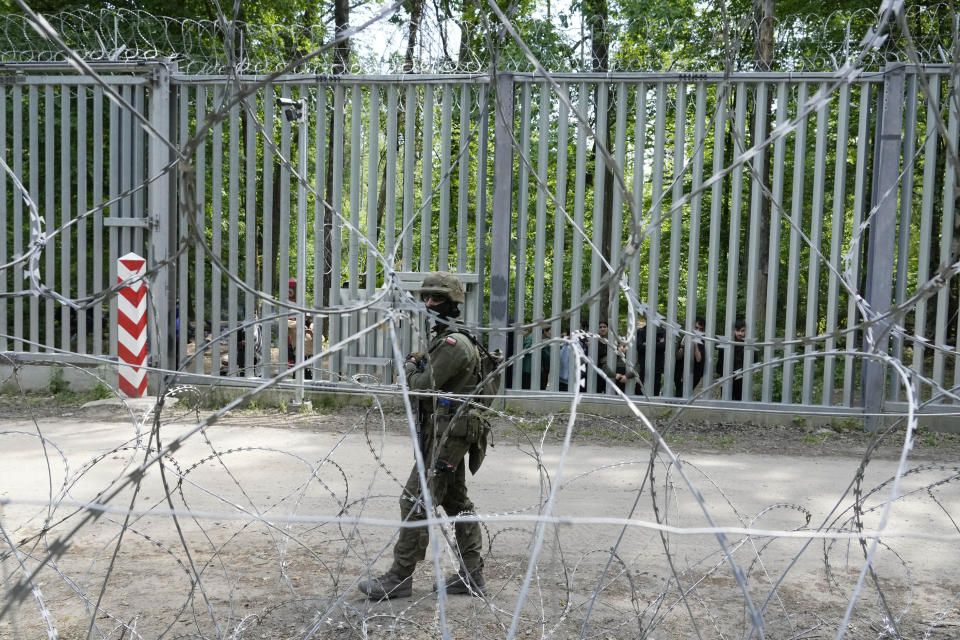 A Polish soldier patrols the metal barrier border with Belarus, in Bialowieza Forest, on Wednesday, May 29, 2024. Poland says neighboring Belarus and its main supporter Russia are behind a surging push by migrants in Belarus toward the European Union. (AP Photo/Czarek Sokolowski)