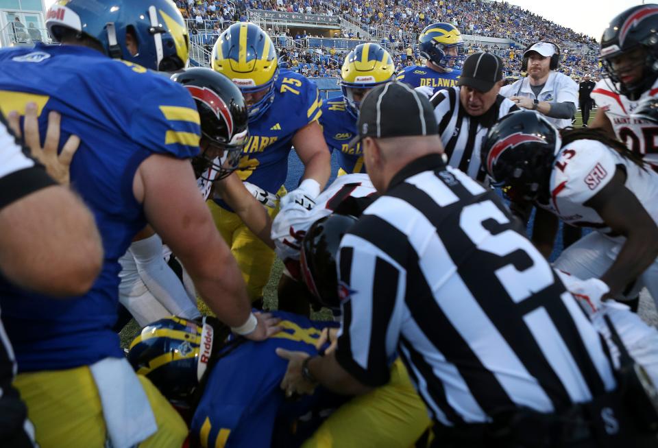 A scuffle breaks out after Delaware scored the second of three touchdowns in the second quarter against St. Francis, prompting Delaware head coach Ryan Carty (top right) to try to straighten out the fray in the end zone at Delaware Stadium, Saturday Sept. 16, 2023.
