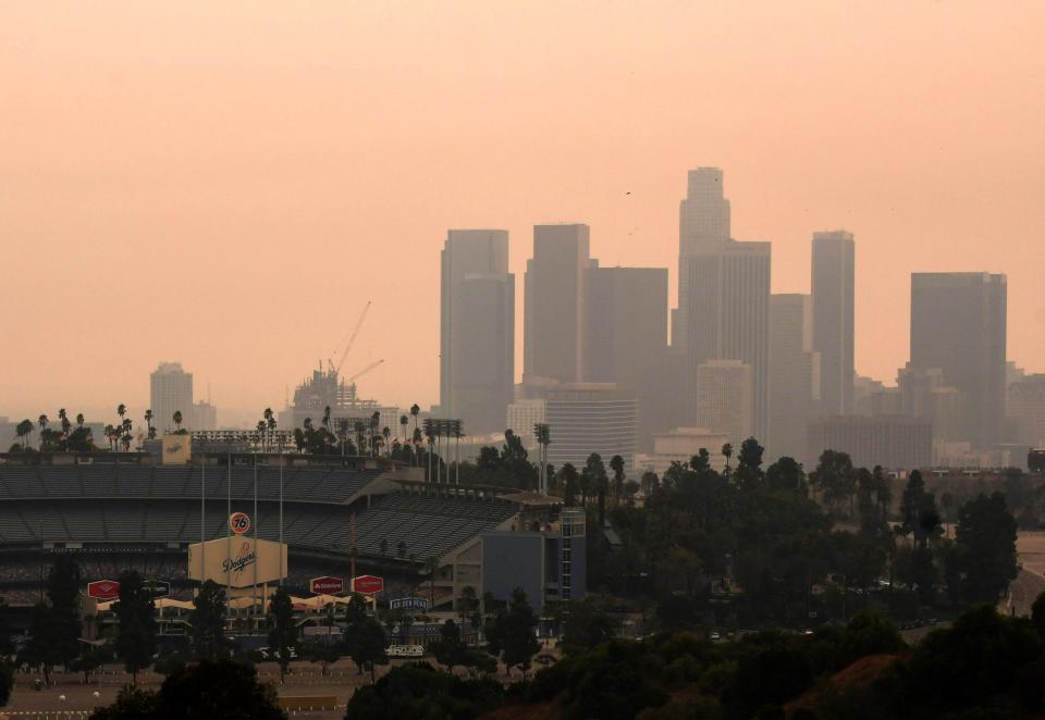 Downtown Los Angeles and Dodger Stadium are shrouded, looking south from Elysian Fields through the smoke from the Bobcat and the El Dorado fires, Friday, Sept. 11, 2020.