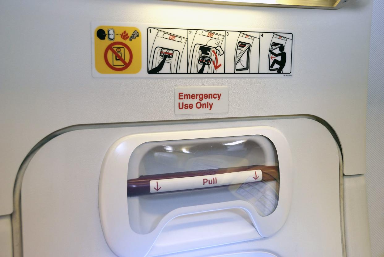 Emergency Exit with door handle in an aircraft cabin