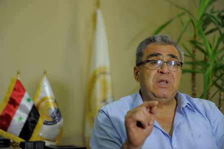 Abdel Nasser Al-Sheikh Fattouh, head of the Homs chamber of commerce, gestures as he talks during an interview with Reuters at his office in Homs city, Syria July 27, 2017. Picture taken July 27, 2017. REUTERS/Omar Sanadiki