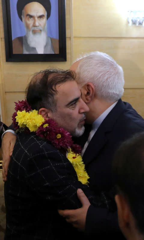 Iran's Foreign Minister Mohammad Javad Zarif greets Iranian professor Massoud Soleimani as he arrives at Mehrabad airport, in Tehran