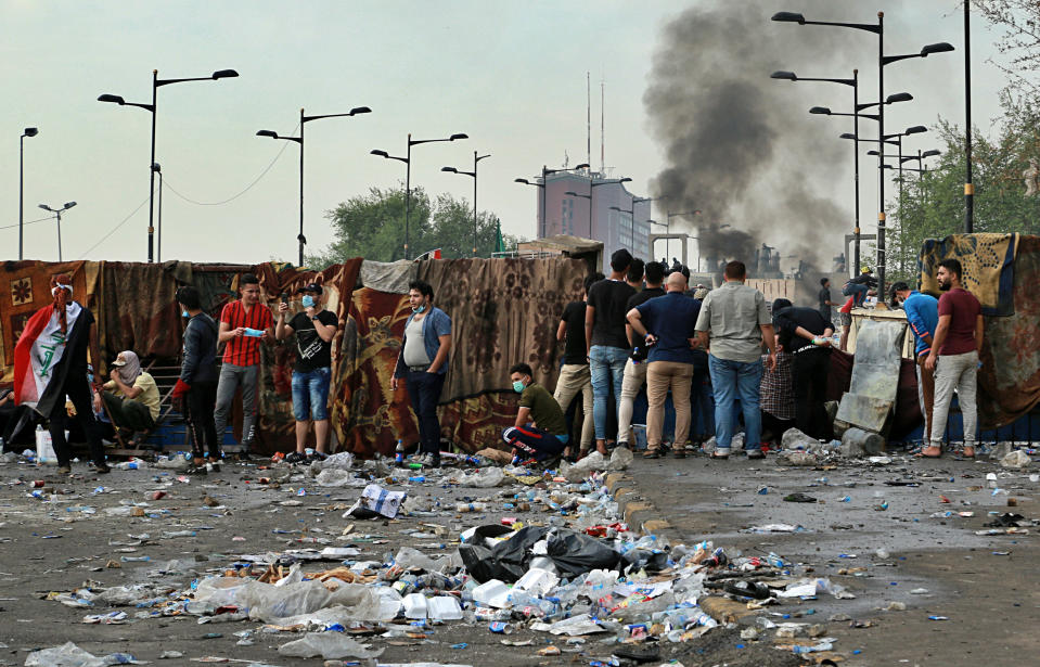 Anti-government protesters set a fire while Iraqi Security forces close the bridge leading to the Green Zone during a demonstration in Tahrir square in Baghdad, Iraq, Sunday, Oct. 27, 2019. Protests have resumed in Iraq after a wave of anti-government protests earlier this month were violently put down. At least 149 people were killed in a week of demonstrations earlier in October. (AP Photo/Hadi Mizban)