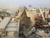 Rescue personnel work on damaged buildings after an earthquake in Tainan, southern Taiwan, February 6, 2016. REUTERS/Pichi Chuang