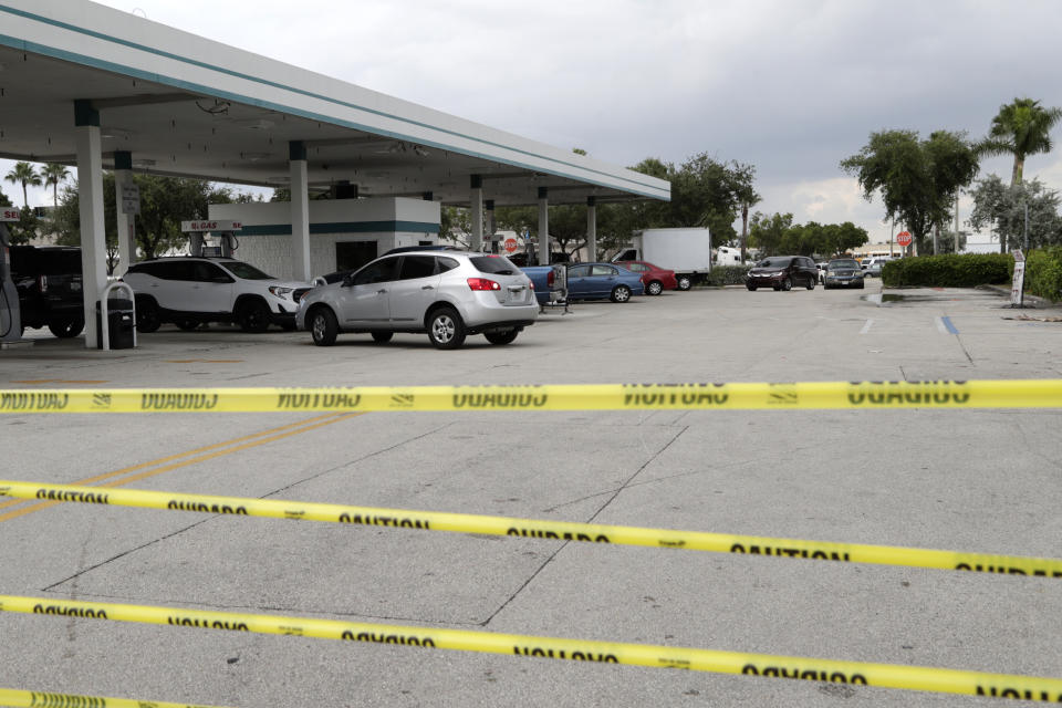 Tape blocks an entrance at BJ's Wholesale Club to control traffic flow as motorists line up for fuel in preparation for Hurricane Dorian, Thursday, Aug. 29, 2019, in Hialeah, Fla. Hurricane Dorian is heading towards Florida for a possible direct hit on the state over Labor Day. (AP Photo/Lynne Sladky)