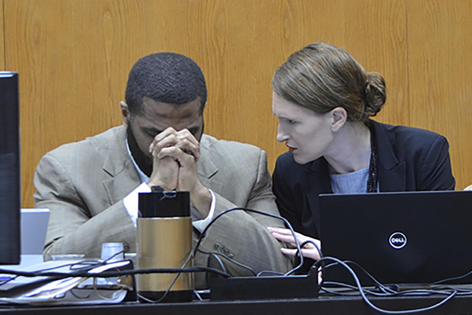 Defendant Willie Cory Godbolt, left, reacts during testimony from his 12-year-old daughter, My'Khyiah Godbolt, that he beat her while defense attorney Katherine Poor comforts him, on Monday, Feb. 17, 2020, during the third day of his capital murder trial at the Pike County Courthouse in Magnolia, Miss. Godbolt, 37, is on trial, for the May 2017 shooting deaths of eight people in Brookhaven. (Donna Campbell/The Daily Leader via AP, Pool)