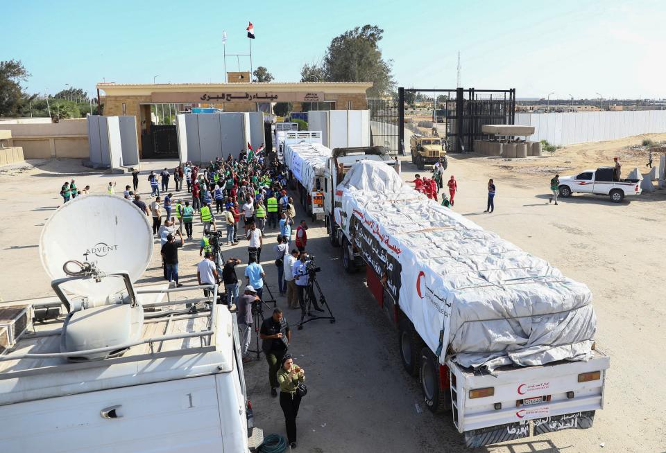 Trucks carrying humanitarian aid from Egyptian NGOs drive through the Rafah crossing from the Egyptian side (REUTERS)