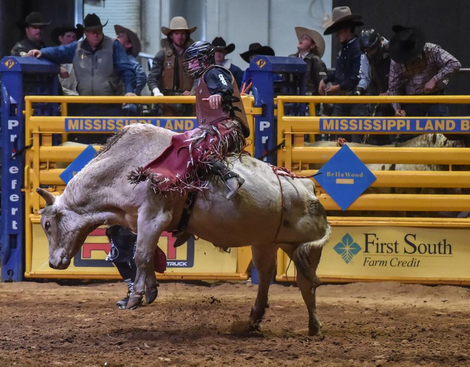 Scott Wells of Snyder, Texas, and his bull Tomahawk compete in the Bull Riding event at the Dixie National Rodeo at the State Fairgrounds as seen in this file photo from last year's event. This year's event is underway at the Coliseum in Jackson.