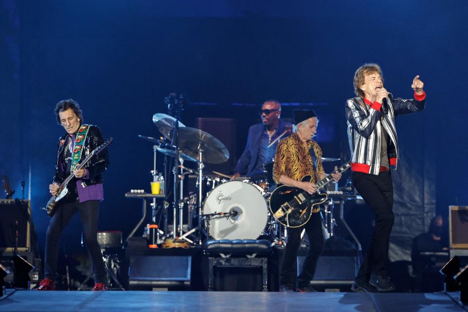 Mick Jagger leads the crowd in another singalong in St. Louis, backed by drummer Steve Jordan and guitarists Ronnie Wood (left) and Keith Richards.