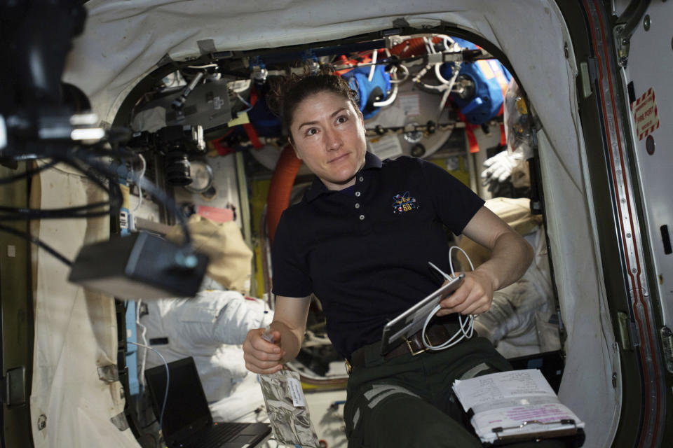 In this April 8, 2019 photo made available by NASA, astronaut and Expedition 59 Flight Engineer Christina Koch works on U.S. spacesuits inside the Quest airlock of the International Space Station. Koch will remain on board until February 2020, approaching but not quite breaking Scott Kelly’s 340-day U.S. record. (NASA via AP)