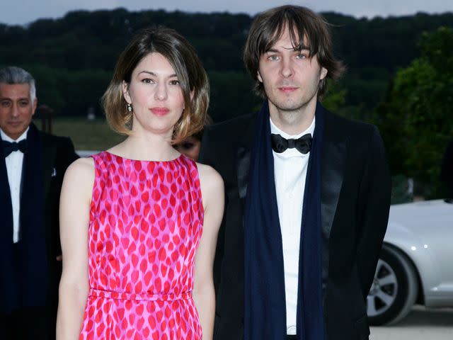 <p>Serge BENHAMOU/Gamma-Rapho/Getty</p> Sofia Coppola and Thomas Mars at a fashion event in Versailles, France, in July 2007.