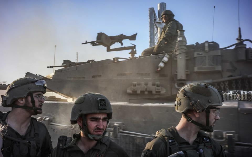 Israeli soldiers stand guard in the Gaza Strip