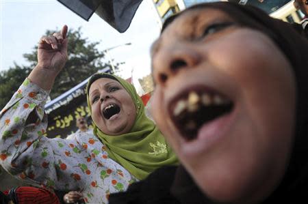 Egyptian women shout slogans during a protest against what they say is Qatar's backing of ousted Egyptian president Mohamed Mursi's government, outside the Qatari Embassy in Cairo November 30, 2013. REUTERS/Stringer
