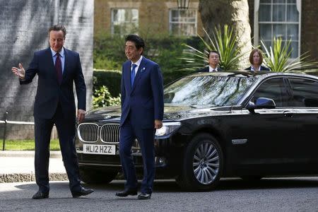 Britain's Prime Minister David Cameron (L) greets his Japanese counterpart Shinzo Abe as he arrives at Number 10 Downing Street in London, Britain May 5, 2016. REUTERS/Stefan Wermuth