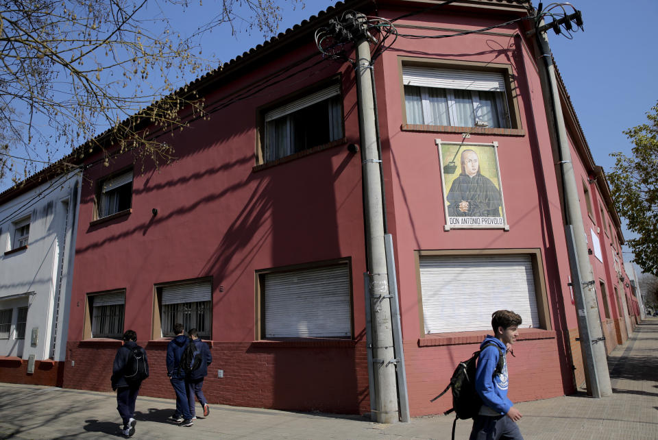 Children walk past the Antonio Provolo Institute in La Plata, Argentina, Thursday, Sept. 6, 2018. Authorities in Argentina carried out raids Thursday at a Catholic-run school for youths with hearing disabilities as part of an investigation into alleged sexual abuse of vulnerable children that has shocked the Pope Francis’s homeland. (Santiago Hafford/La Nacion via AP) ARGENTINA OUT - NO PUBLICAR EN ARGENTINA