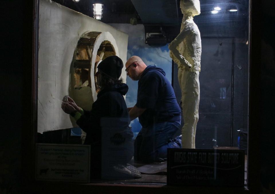 Sarah Pratt, left, and her husband, Adam Pratt, begin work on the 2023 Kansas State Fair butter sculpture Friday morning. This year, the sculpture is of famous Kansan and aviation legend Amelia Earhart.