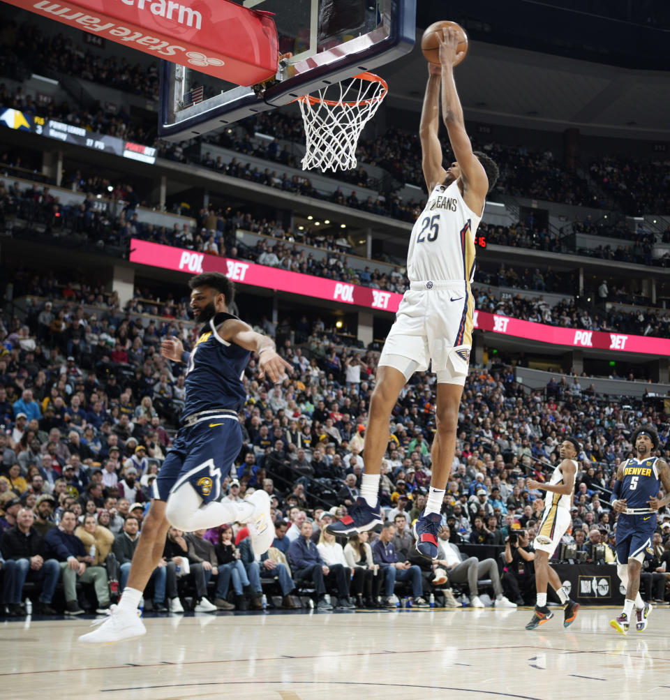 New Orleans Pelicans guard Trey Murphy III, right, goes up for a basket as Denver Nuggets guard Jamal Murray defends in the second half of an NBA basketball game Tuesday, Jan. 31, 2023, in Denver. (AP Photo/David Zalubowski)