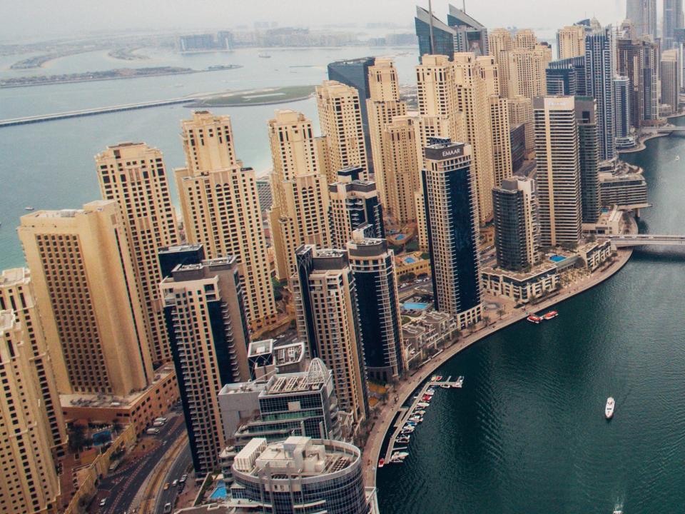 The Dubai Marina and Jumeirah Beach Residences (L) are seen from above on February 8, 2017 in Dubai, United Arab Emirates.