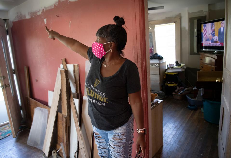 Tracey Watkins points to where her roof and ceiling were damaged in her home Thursday, Aug. 13, 2020 in Nashville, Tenn.