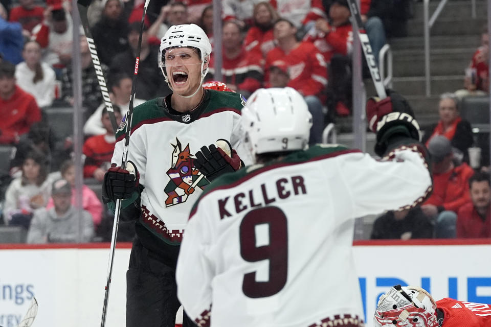 Arizona Coyotes center Nick Bjugstad is greeted by right wing Clayton Keller (9) after scoring during the third period of an NHL hockey game, Thursday, March 14, 2024, in Detroit. (AP Photo/Carlos Osorio)