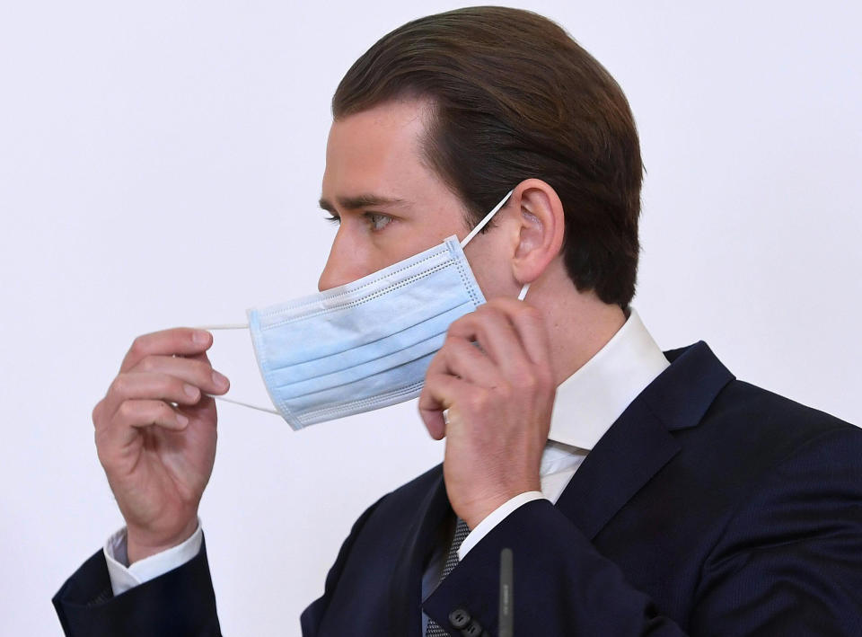 Austrian Chancellor Sebastian Kurz adjust a face mask during a news conference about the coronavirus situation in Austria, in Vienna, Austria, Monday, April 6, 2020. The COVID-19 coronavirus causes less serious symptoms for most people, but for some it causes severe illness and even death.(Helmut Foringer/Pool via AP)