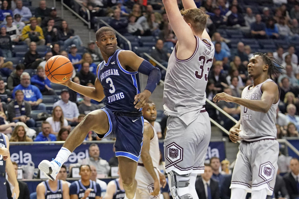 BYU guard Rudi Williams (3) passes the ball as Missouri State forward Dawson Carper (33) defends during the second half of an NCAA college basketball game Wednesday, Nov. 16, 2022, in Provo, Utah. (AP Photo/Rick Bowmer)
