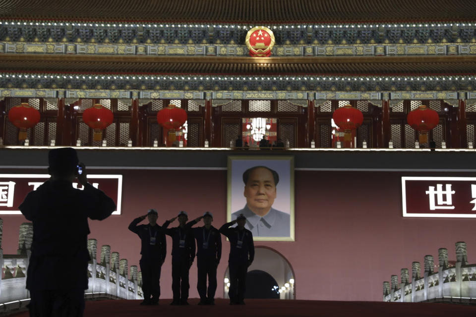 Security personnel pose in front of Mao Zedong’s portrait on Tiananmen Gate  for the 70th anniversary of the founding of the People’s Republic of China in Beijing on Oct. 1, 2019.  