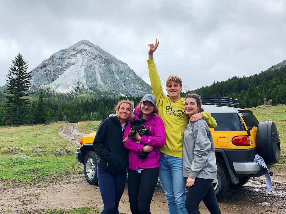 Four people in front of an FJ Cruiser