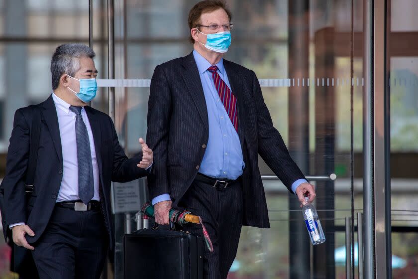 Los Angeles , CA - January 20: Raymond Chan, left, a former Los Angeles deputy mayor, and his attorney Harland Braun after a hearing for his upcoming trial on racketeering, fraud and bribery charges, exit Federal Court on Friday, Jan. 20, 2023 in Los Angeles , CA. (Irfan Khan / Los Angeles Times)