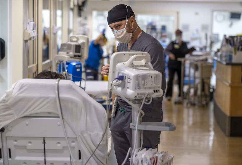 TORRANCE, CA - JANUARY 11: Dr. Leo Rodriguez, MD is talking with a patient in the Emergancy Department at Providence Little Company of Mary Medical Center on Tuesday, Jan. 11, 2022 in Torrance, CA. The emergency department is currently busy with both Covid19 and non Covid19 patients. (Francine Orr / Los Angeles Times)