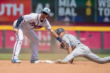 Jun 17, 2018; Atlanta, GA, USA; San Diego Padres left fielder Travis Jankowski (16) is tagged out by Atlanta Braves shortstop Dansby Swanson (7) after his foot came off the base on a steal attempt during the sixth inning at SunTrust Park. Mandatory Credit: Dale Zanine-USA TODAY Sports