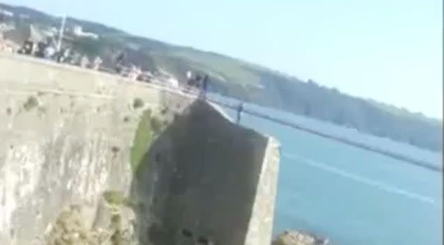 The boy can be seen at the top of the cliff. Photo: YouTube