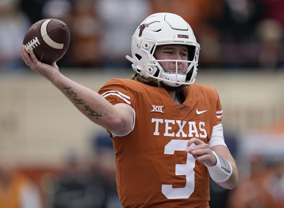 FILE - Texas quarterback Quinn Ewers looks to pass against Baylor during the first half of an NCAA college football game in Austin, Texas, Nov. 25, 2022. Texas opens their season at home against Rice on Sept. 2. (AP Photo/Eric Gay, File)