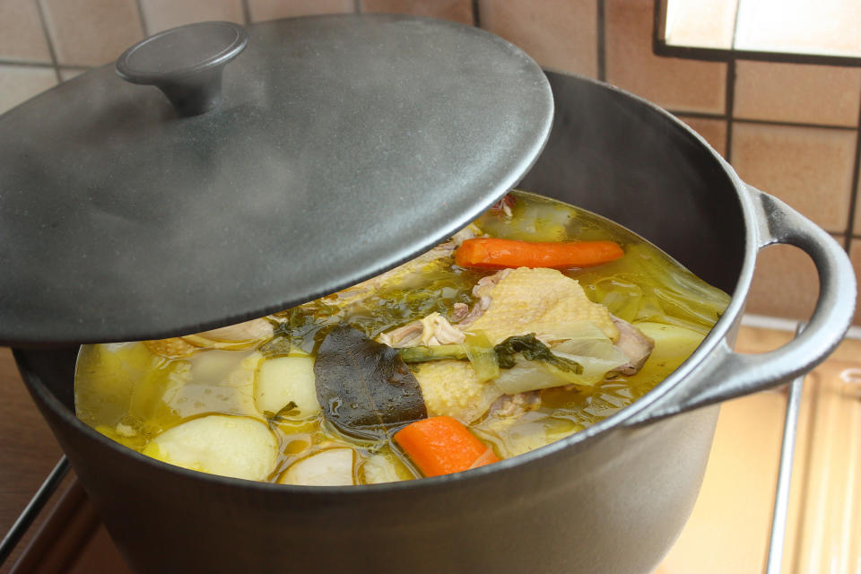 chicken stock being simmered in a large pot