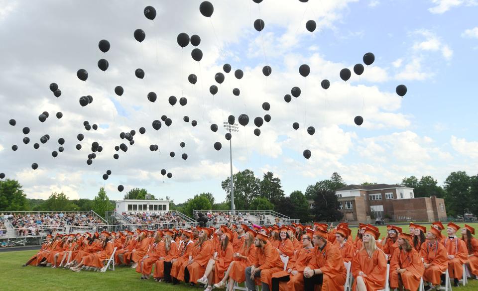 Plainfield High School graduates release bio-degradable balloons in remembrance of fellow graduate Andrew Vincent who died in a motor vehicle accident in April during their commencement exercises Friday. There were 114 graduates.